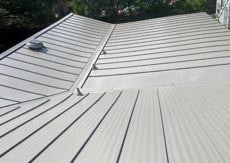 Solar attic fan installed on a metal roof for Roof Ventilation in Waukee